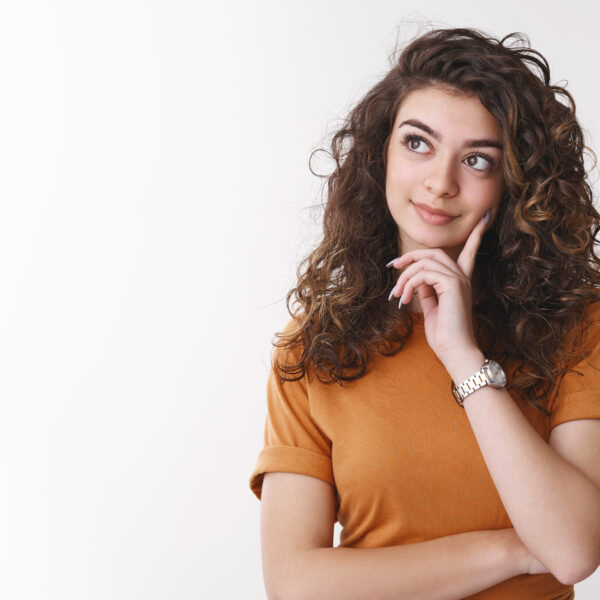 Cute dreamy girl deciding what product better look up thoughtful touch chin thinking smiling shopping alone, standing white background making choice considering proposals, white background.